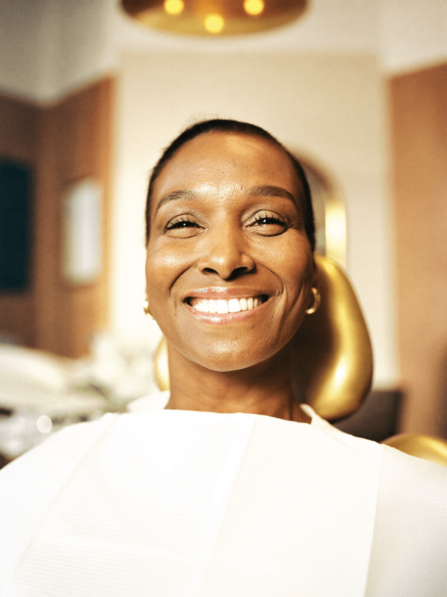A radiant patient with a full set of teeth after All-on-4 implants
