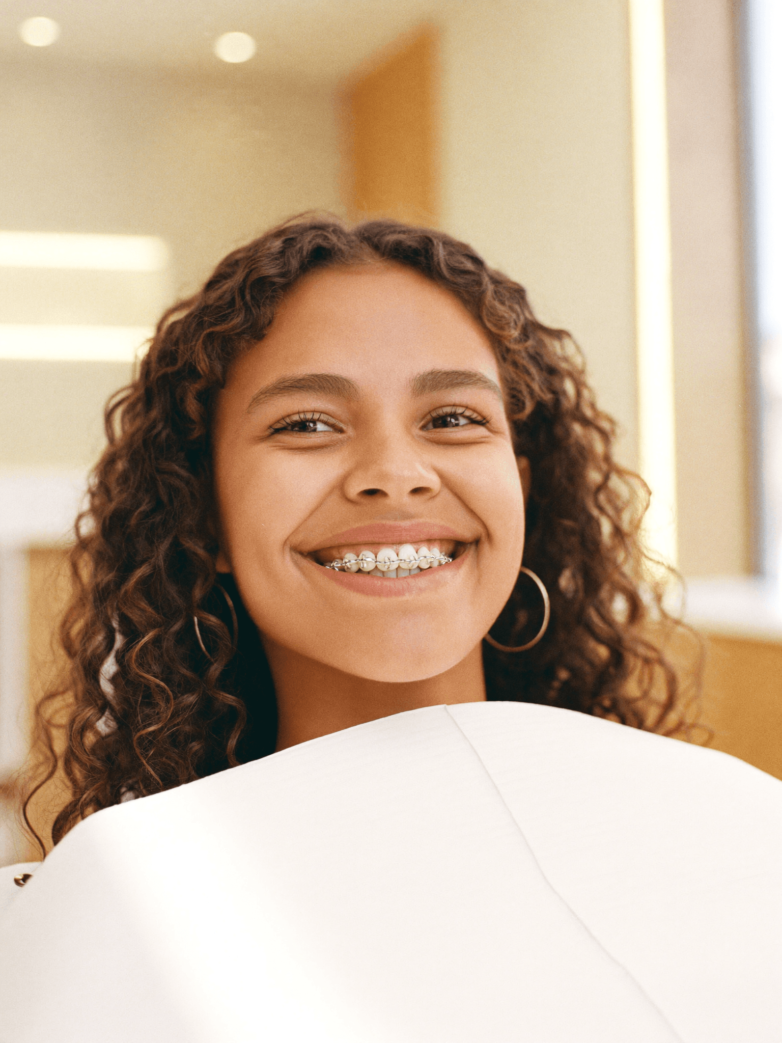 A happy patient smiling with modern orthodontic braces