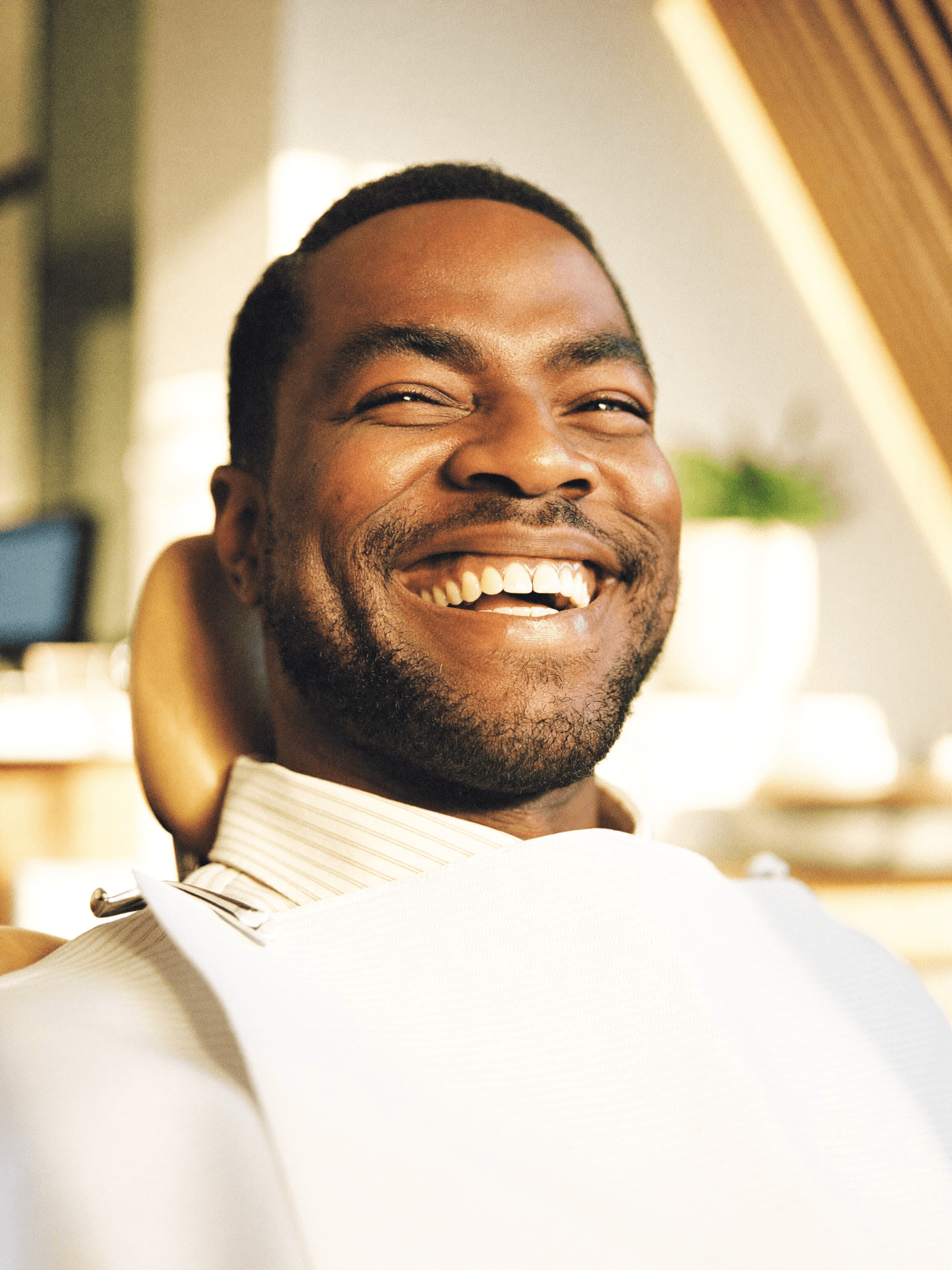 A confident patient with a full, restored smile after dental implants